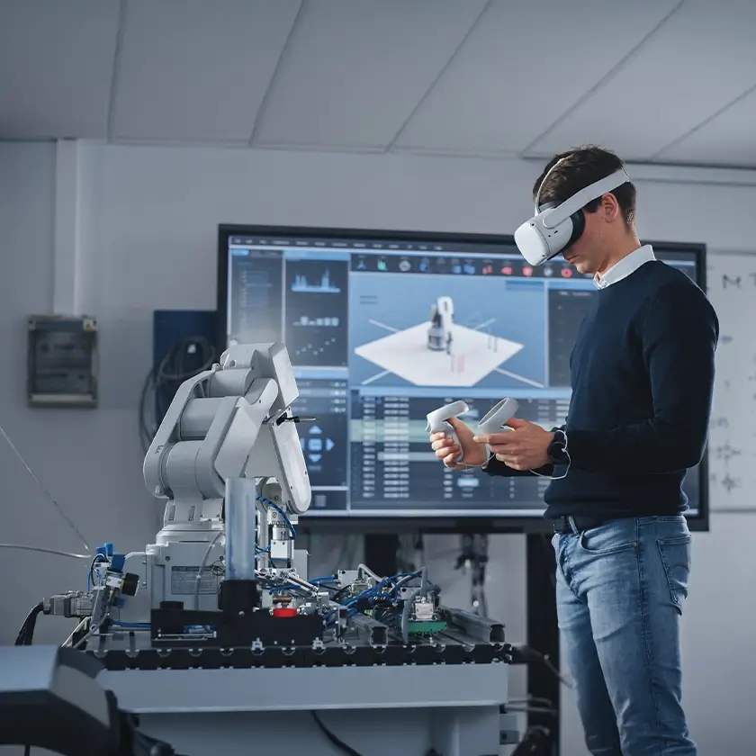 Man in VR headset, robotic arm